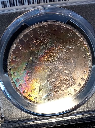 1883 O Morgan Dollar. MS63.  Rainbow and Textile Toned.