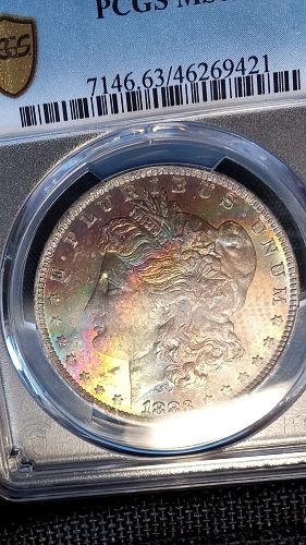 1883 O Morgan Dollar. MS63.  Rainbow and Textile Toned.