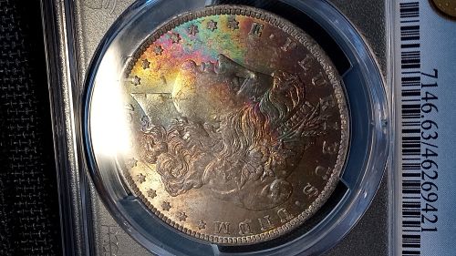 1883 O Morgan Dollar. MS63.  Rainbow and Textile Toned.