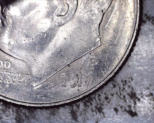 2017 P dime struck through a grease filled die